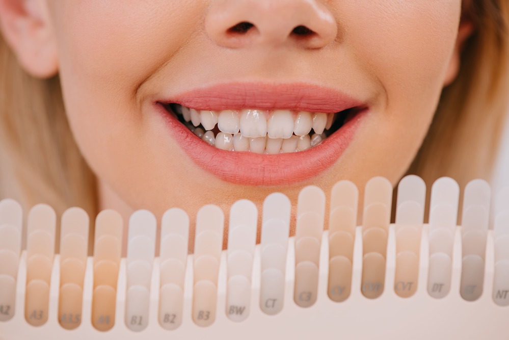 cropped view of smiling woman holding teeth color 2023 11 27 05 14 25 utc 1